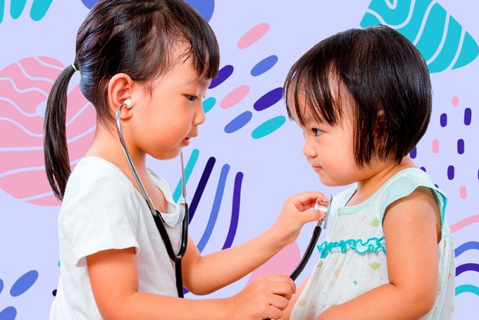 two little girls playing with a stethoscope