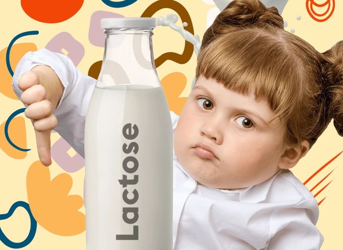 A young girl holding a thunbs down with a bottle of milk, marked 'lactose'