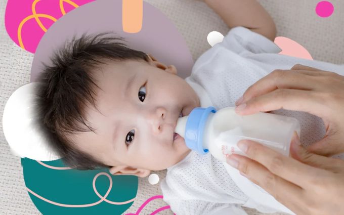 A woman feeding a baby with a bottle of Formula - Supplementing