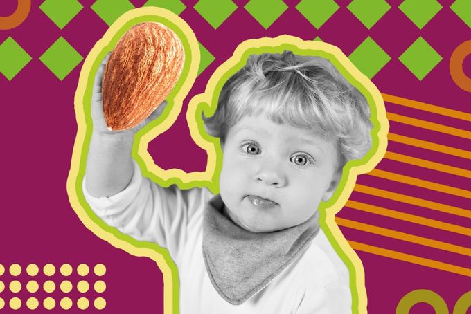 a young boy holding a piece of fruit in his hand