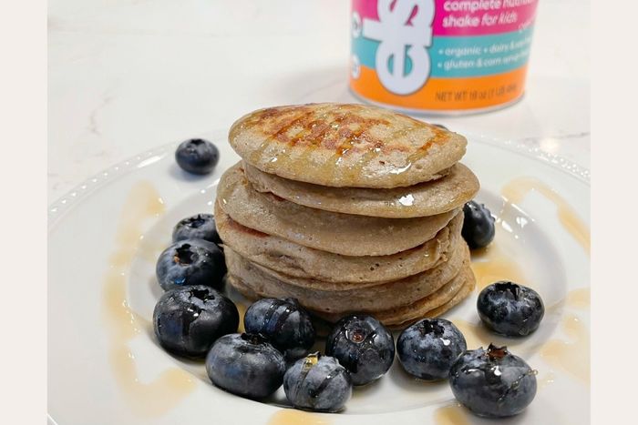 a stack of pancakes sitting on top of a white plate