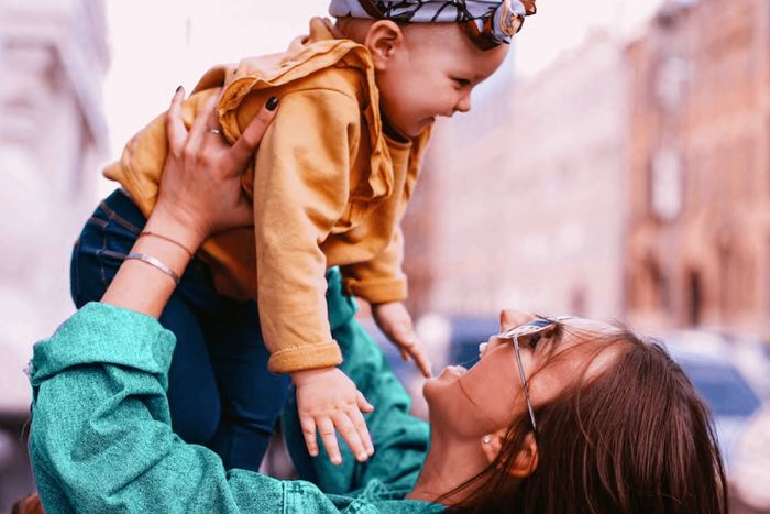 a woman holding a baby up to her face