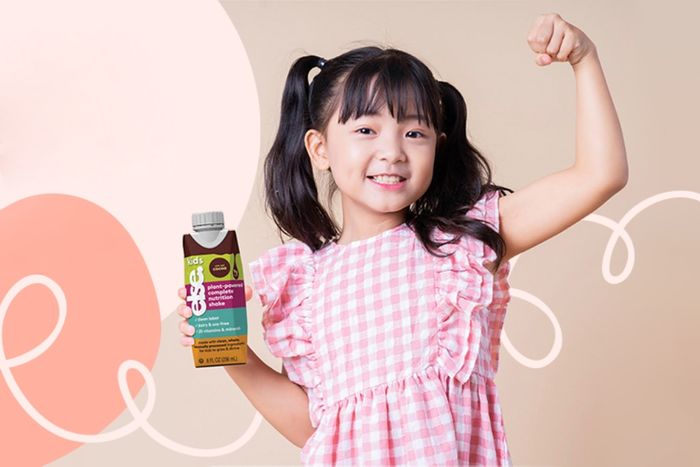 a little girl holding a bottle of sunflower seed oil
