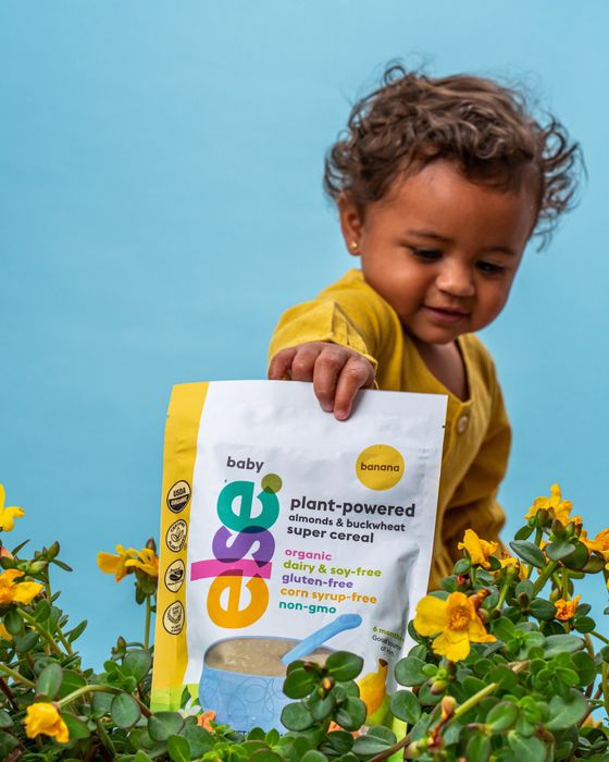 a young child holding a bag of plant powered coffee