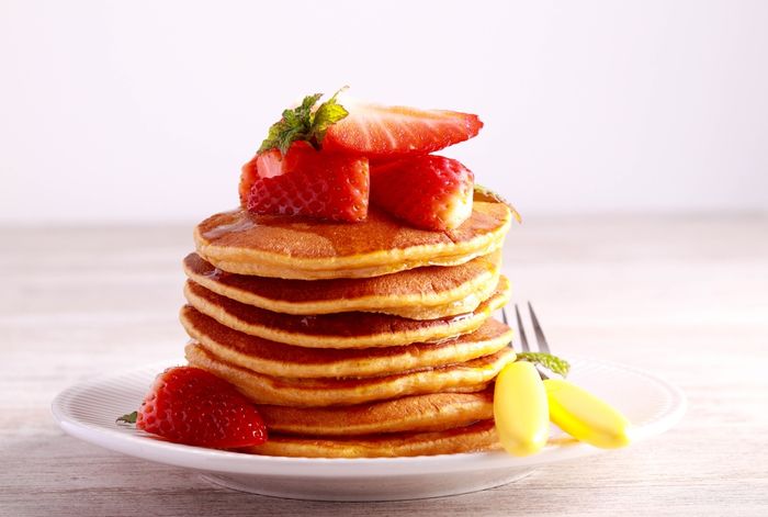 a stack of pancakes with strawberries on top