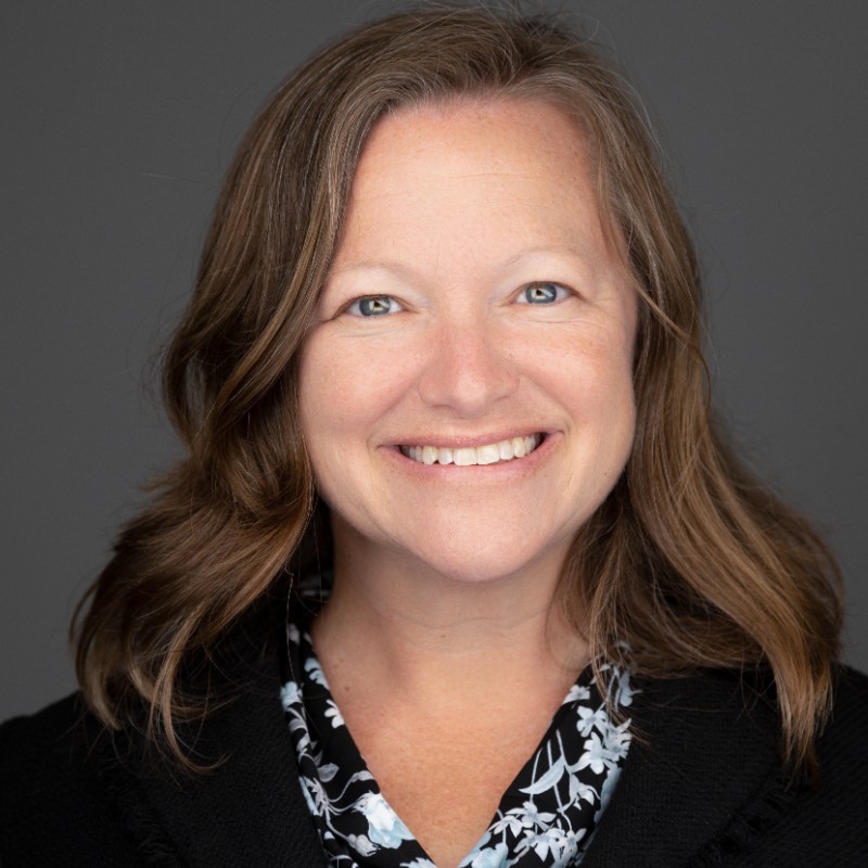 a smiling woman with long hair and a black shirt