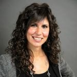 a woman with curly hair and a black shirt