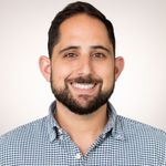 a man with a beard smiling at the camera