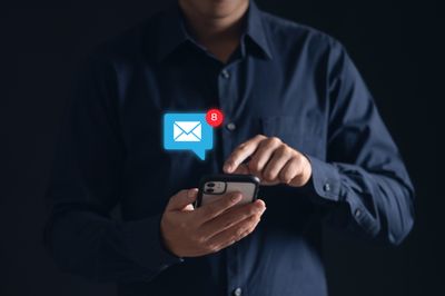 A man checks his inbox on his phone.