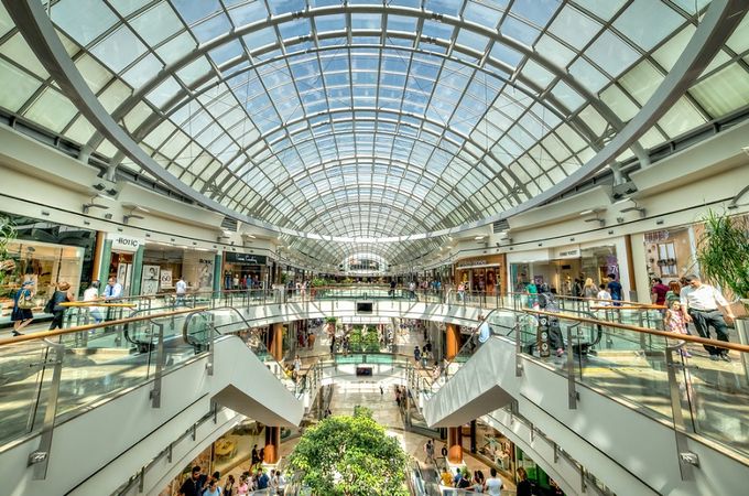 A mall filled with lots of people walking around