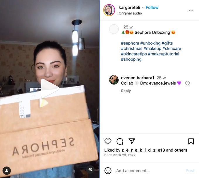 a woman holding a cardboard box with the word sephora on it