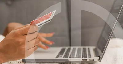 female hands typing card numbers into a laptop