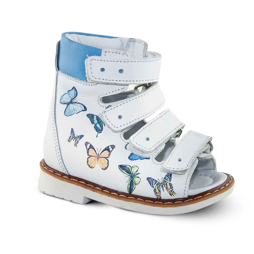 a child's white shoe with butterflies on it
