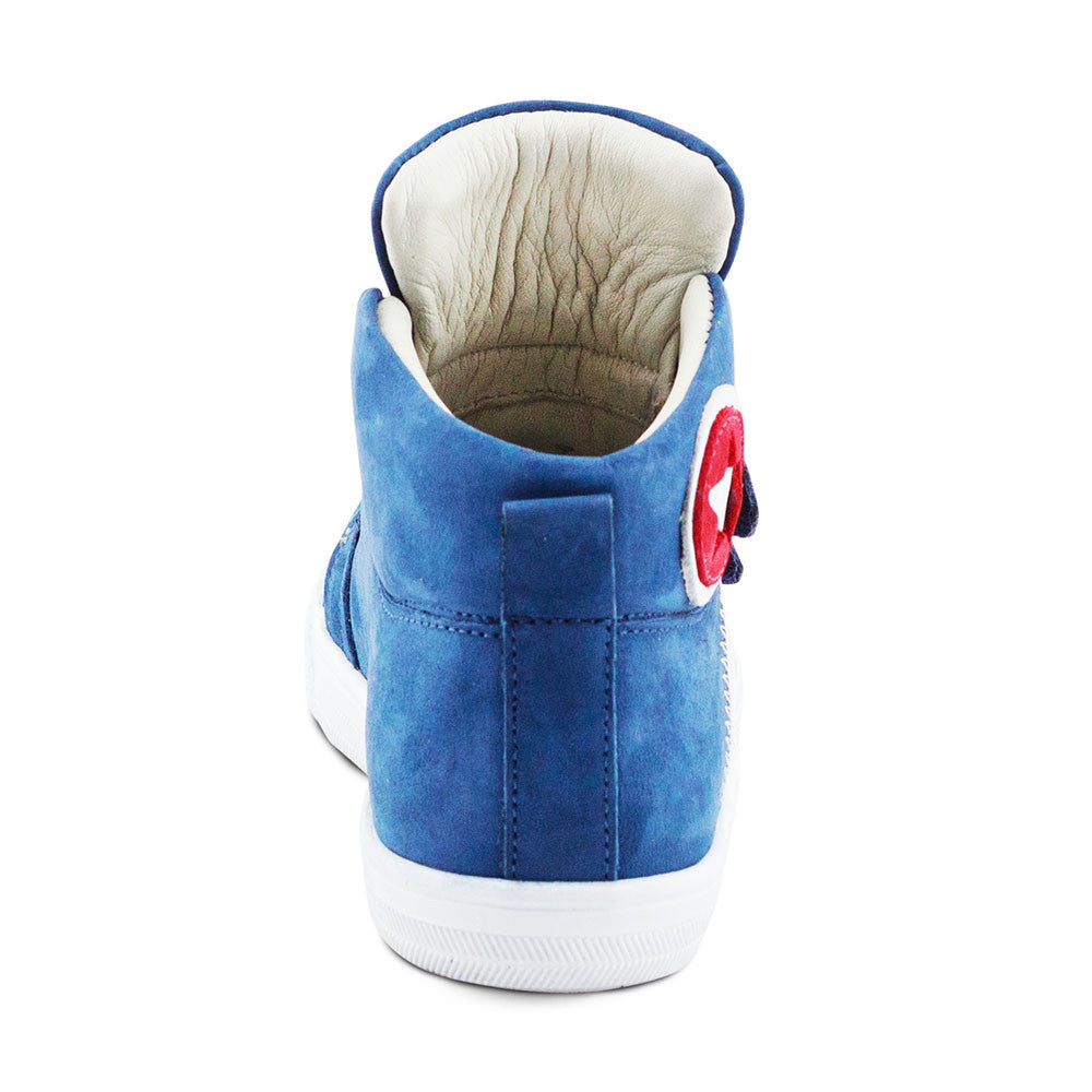 a blue sneaker with a red and white button on the side