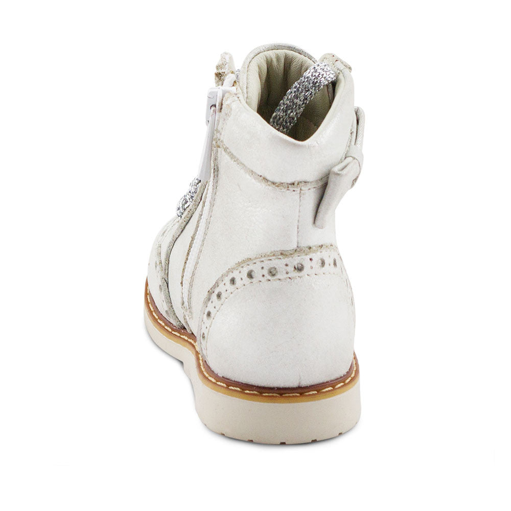 a child's white boot with a bow on the side