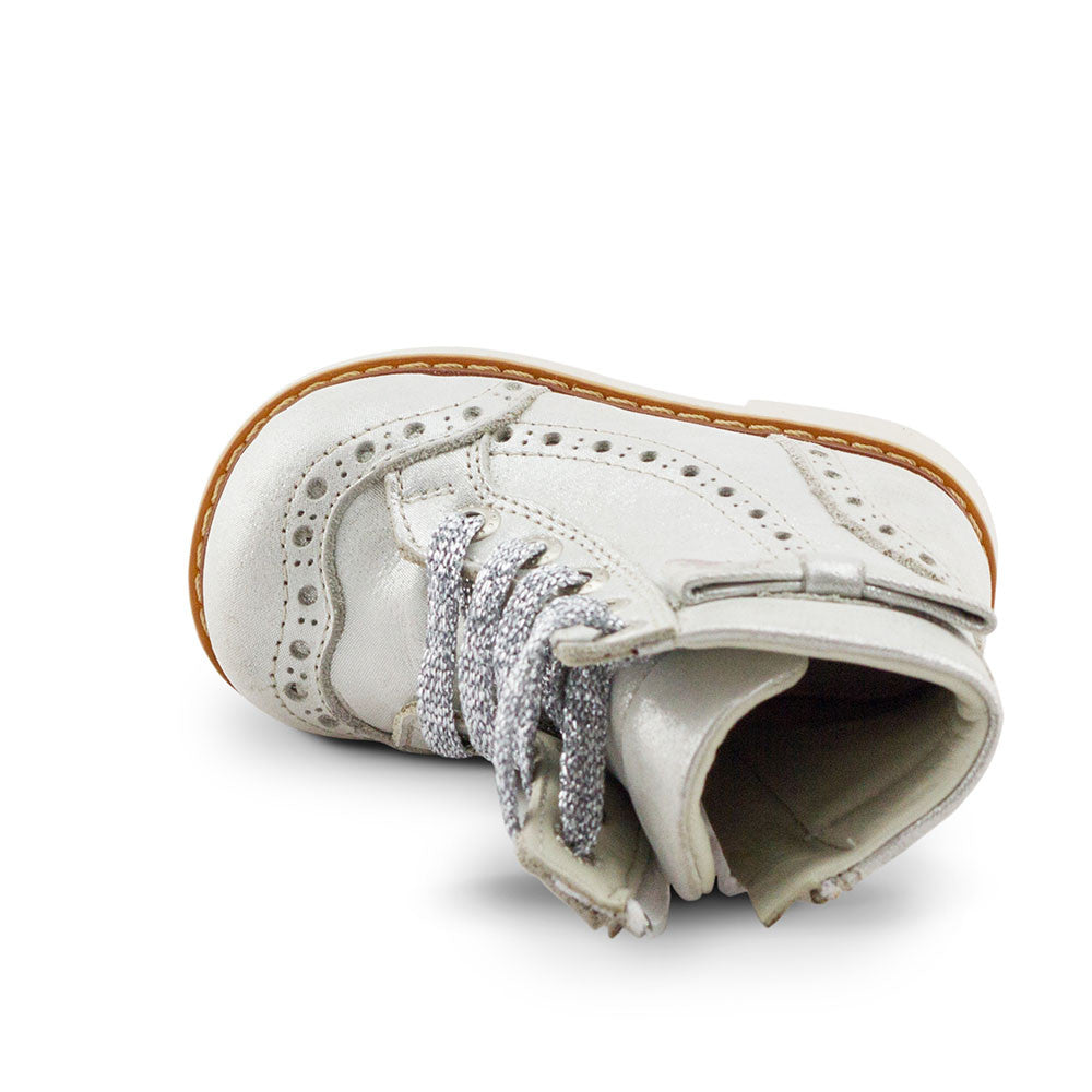 a pair of white shoes on a white background