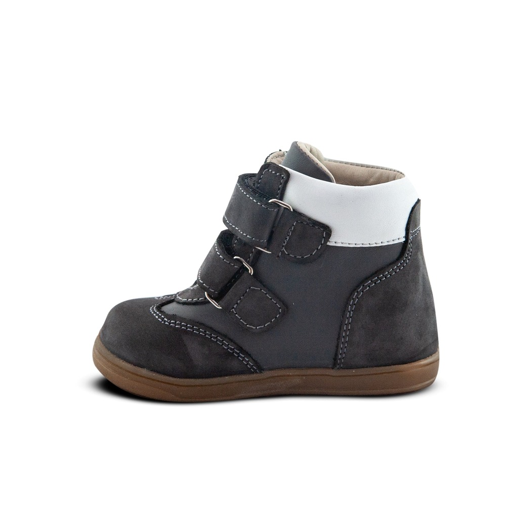 a child's gray and white shoe with a brown sole