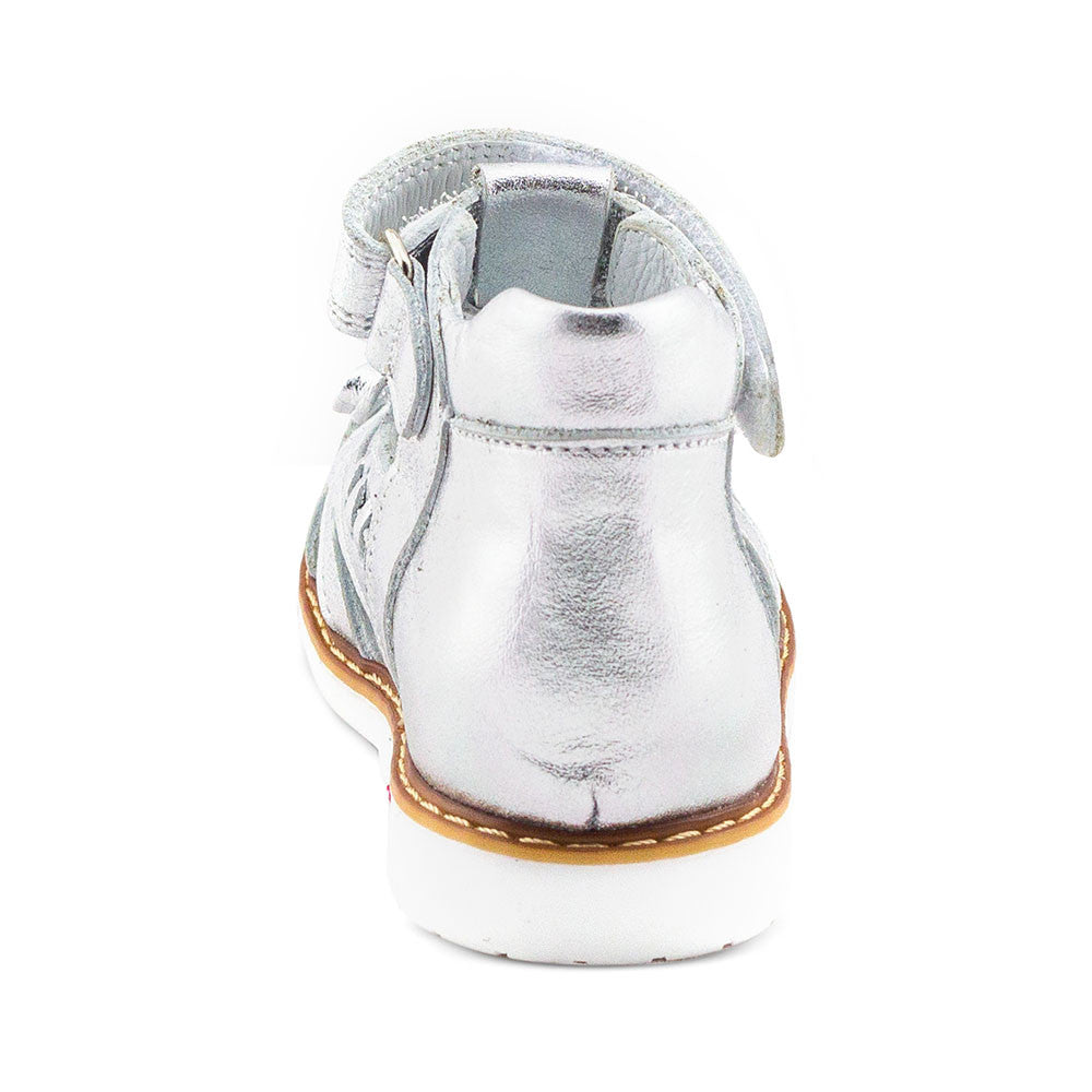 a child's silver shoe with a white sole