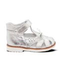 a little girl's silver shoes on a white background