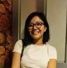 a woman wearing glasses and a white shirt