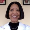 a woman in a lab coat smiling for the camera