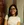 a woman wearing glasses and a white shirt