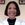 a woman in a lab coat smiling for the camera