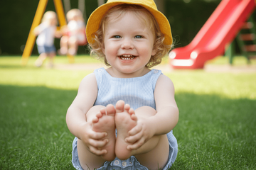 A toddler who walks with one foot turned in sitting down.