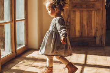 A toddler wearing ankle support shoes.