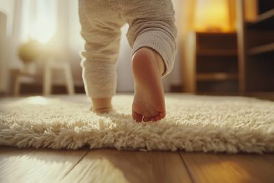 A baby walking barefoot.