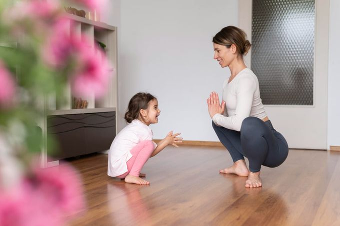 A woman showing her daughter how to do exercises to help correct her child's intoeing.