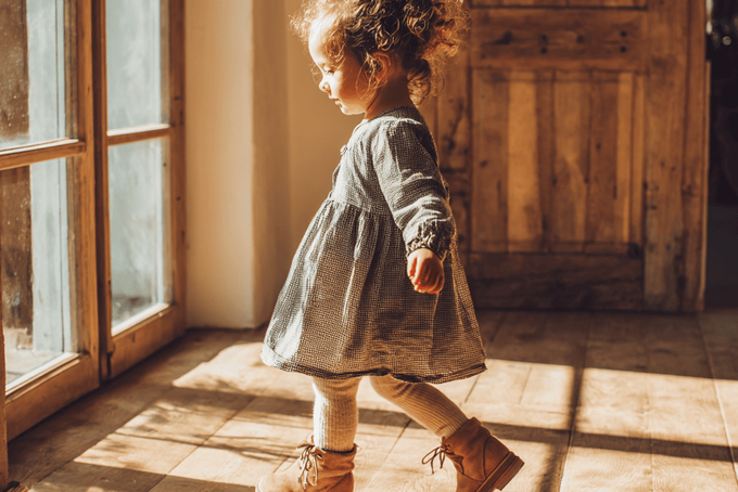 A toddler wearing ankle support shoes.