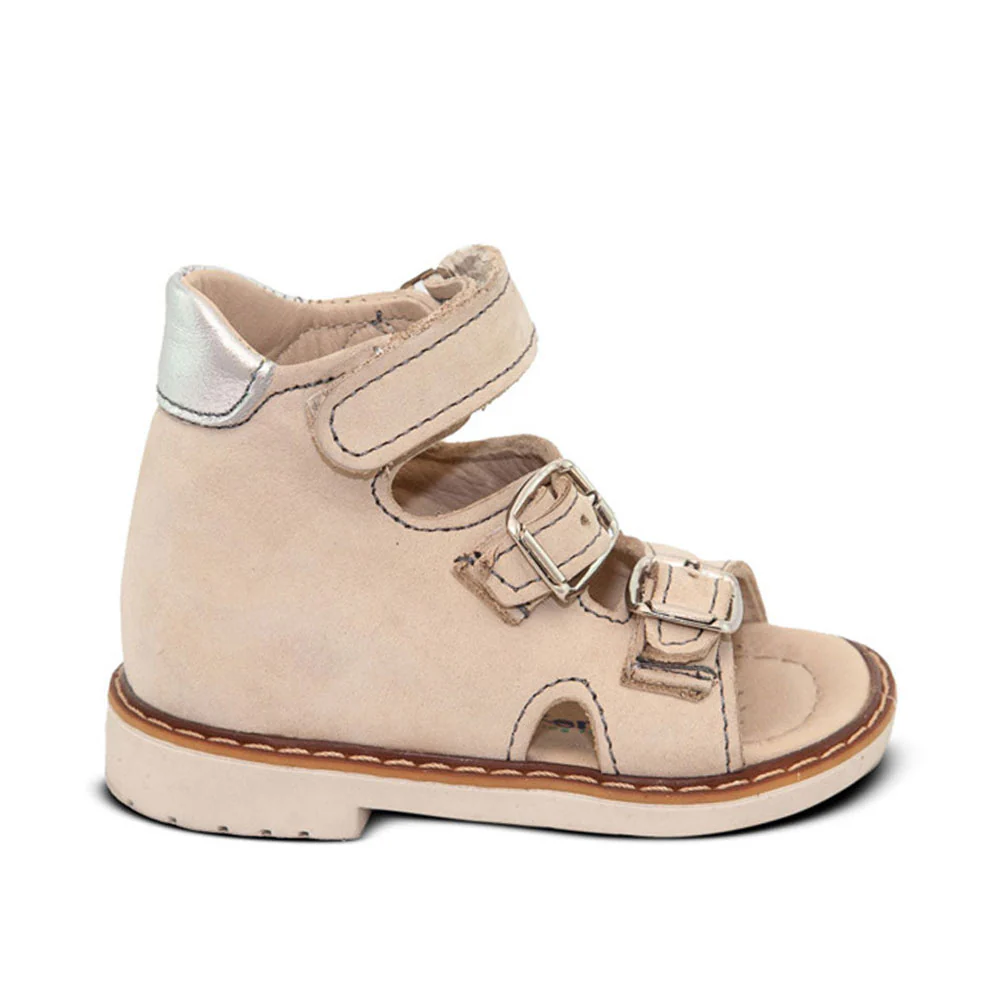 a little girl's white shoe with two straps