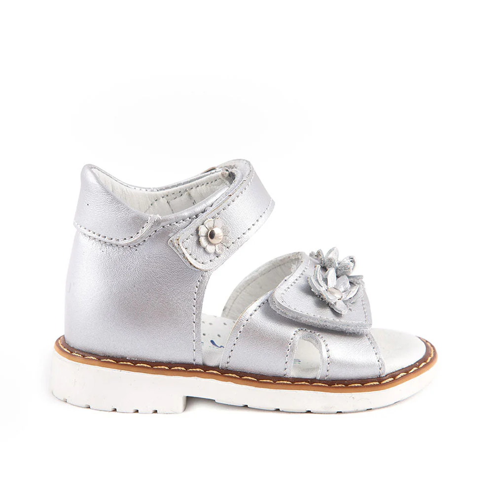 a silver shoe with a flower on the side