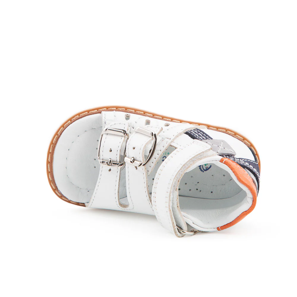 a pair of white sandals with orange straps