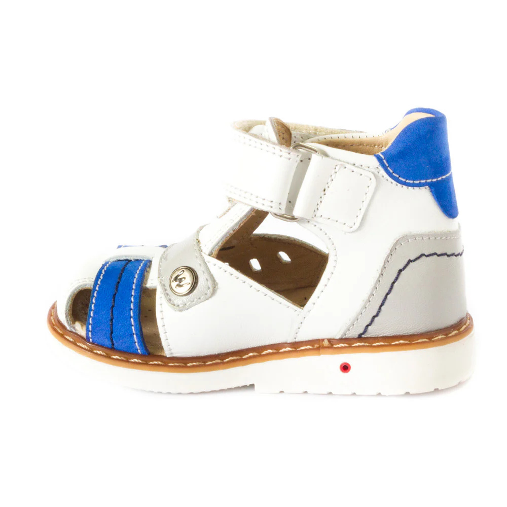 a child's white and blue shoe with a brown sole