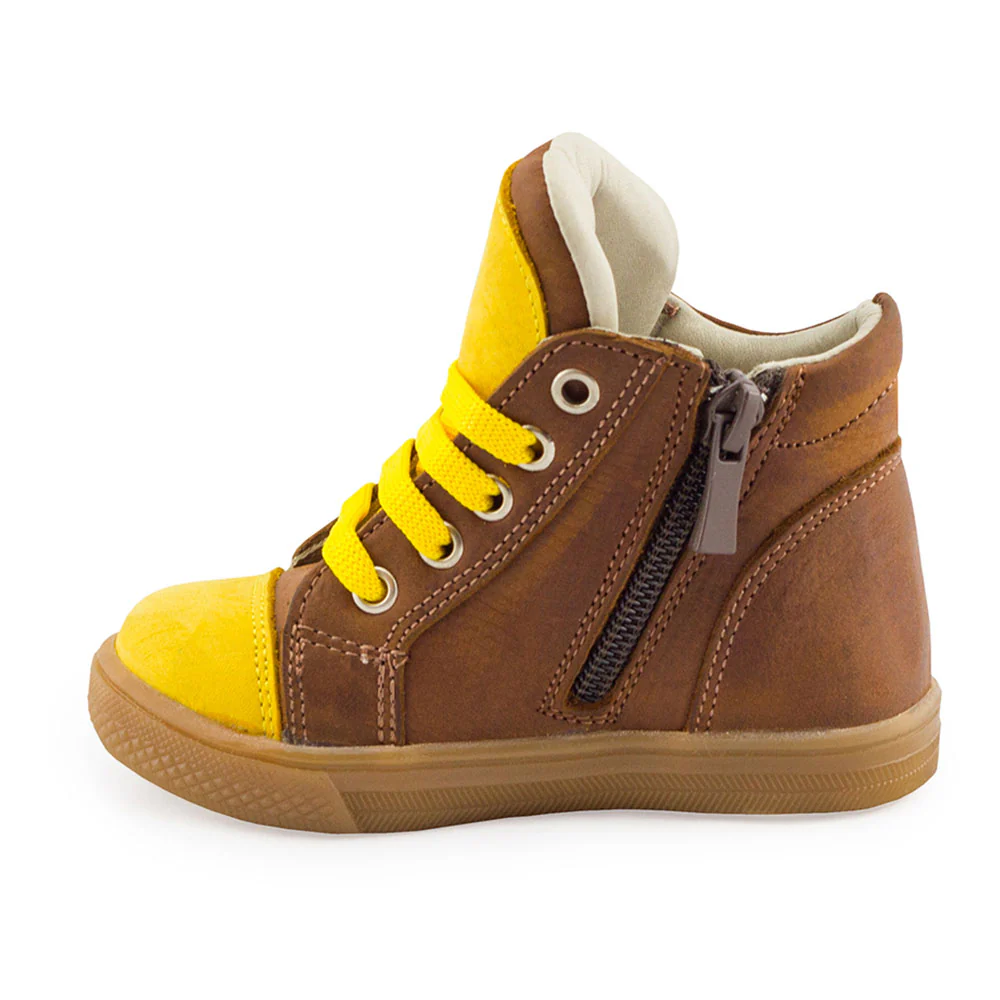 a child's brown and yellow shoe with zippers
