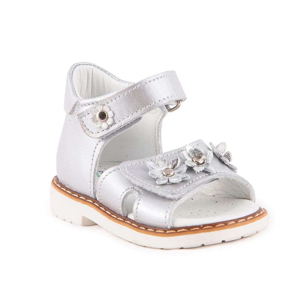 a little girl's silver sandals with flowers