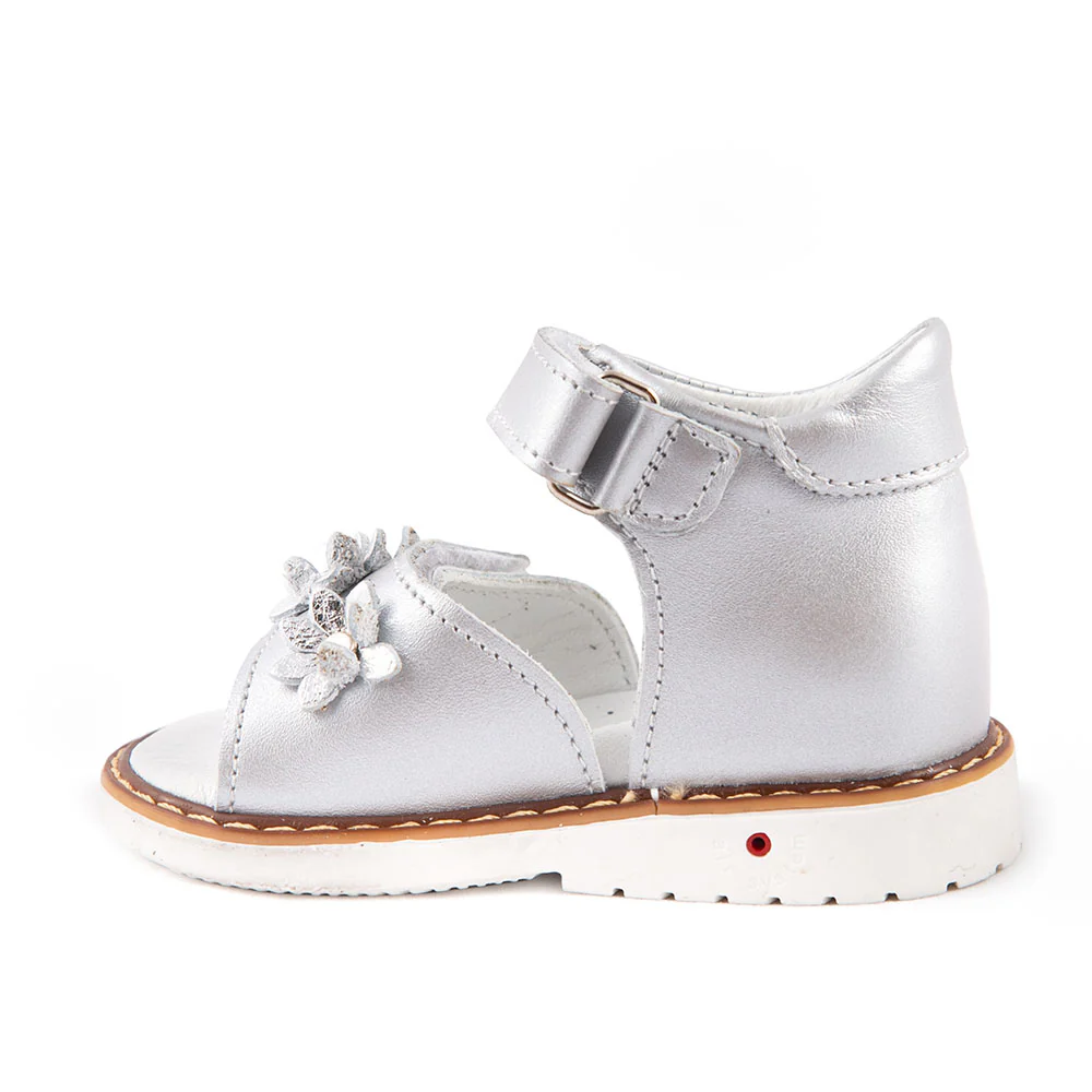 a white shoe with a flower on the side