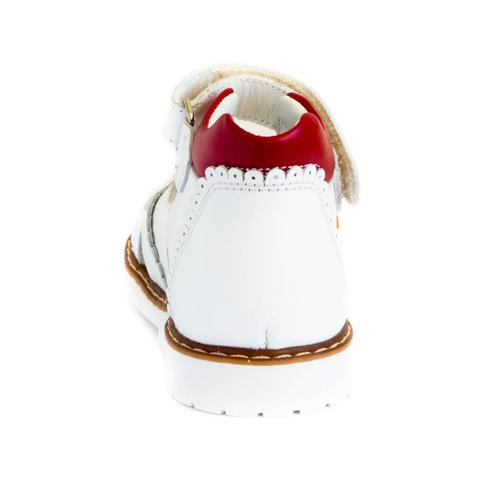 a white shoe with a red shoelace on top of it