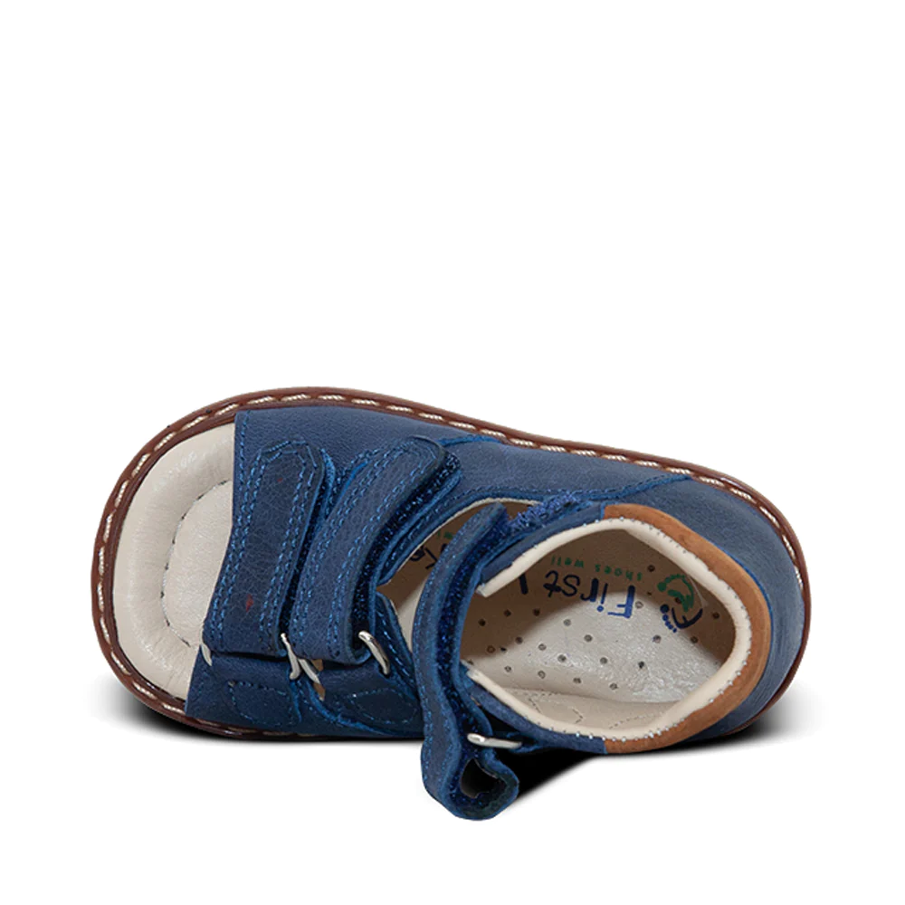 a pair of blue shoes with a white sole