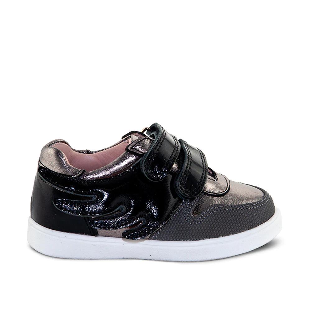 a little girl's black and silver sneakers