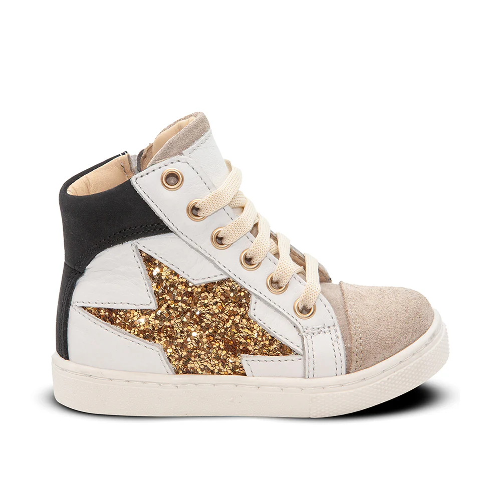 a white and gold sneaker with a star on the side