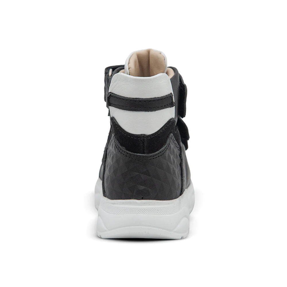 a pair of black and white sneakers on a white background