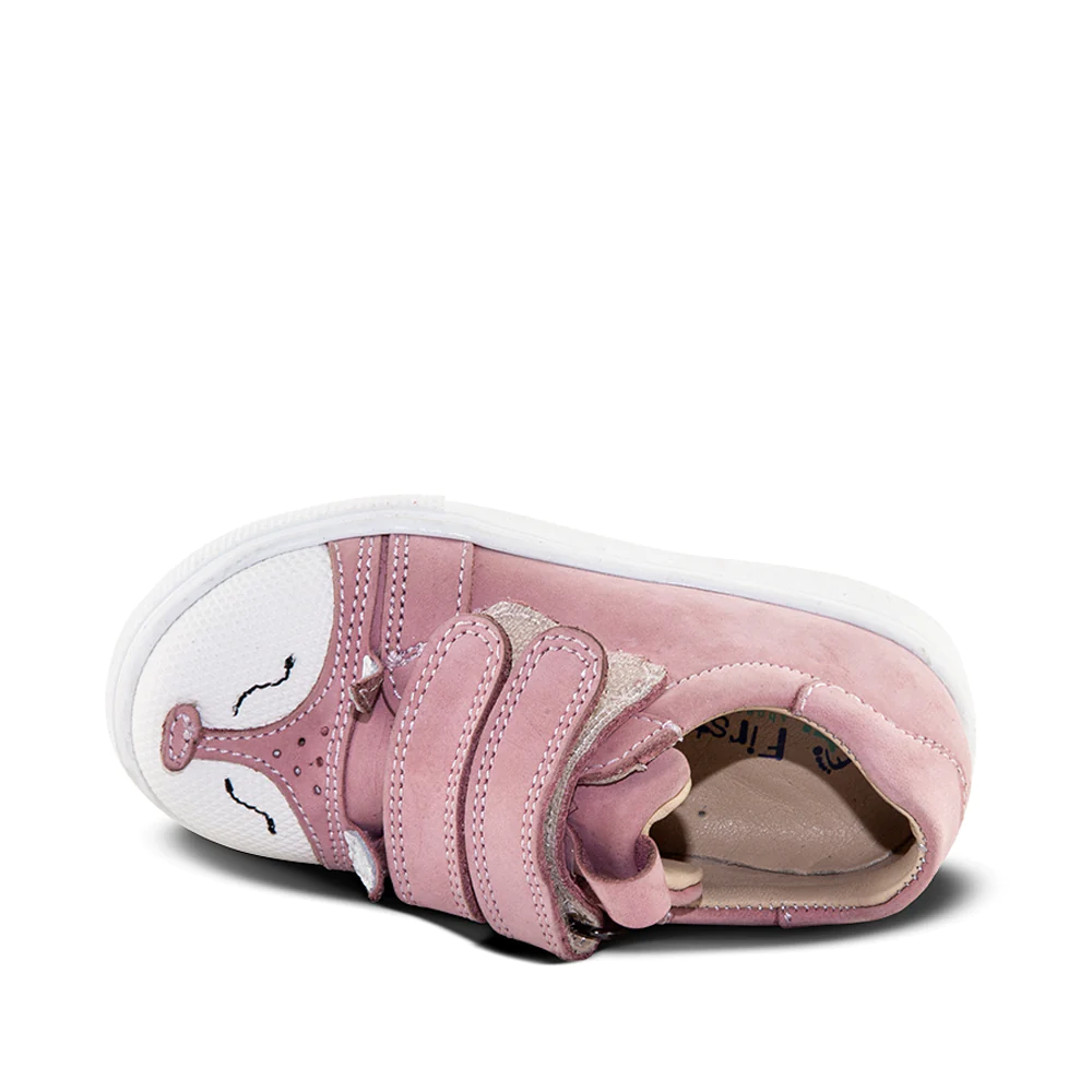 A child's pink sneaker with two straps - top-down view