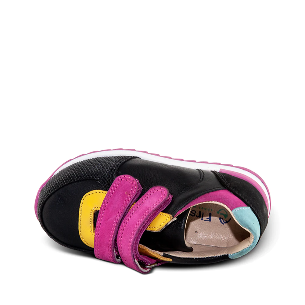 A child's black and yellow sneaker with pink straps