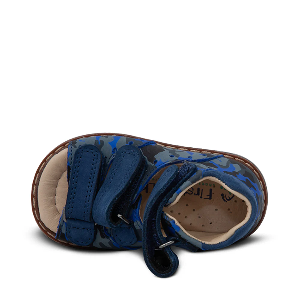 a toddler's shoe with a blue camouflage print