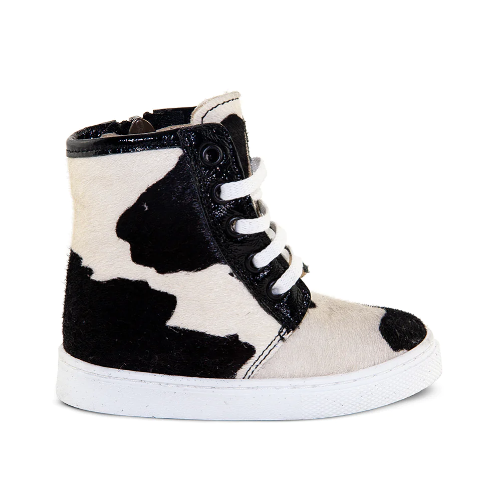 a black and white cow print high top sneaker