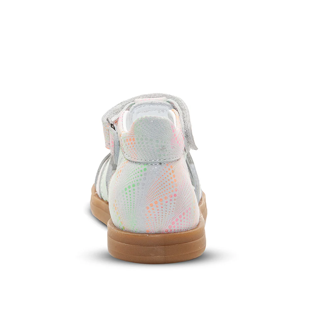 a child's white and pink sneaker on a white background