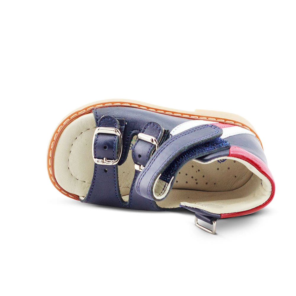 a child's shoe with two straps and a buckle